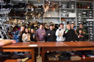 college students smile during leather making class while studying abroad