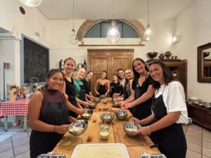 college study abroad students make pasta in a local foods cooking class