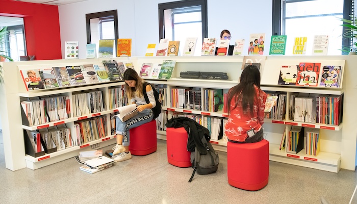 Library at Elisava with students browsing design magazines